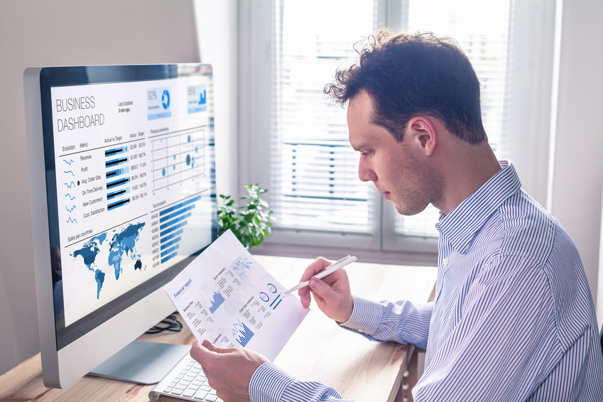 Businessman working with KPI dashboard metrics, BI graph, financial report